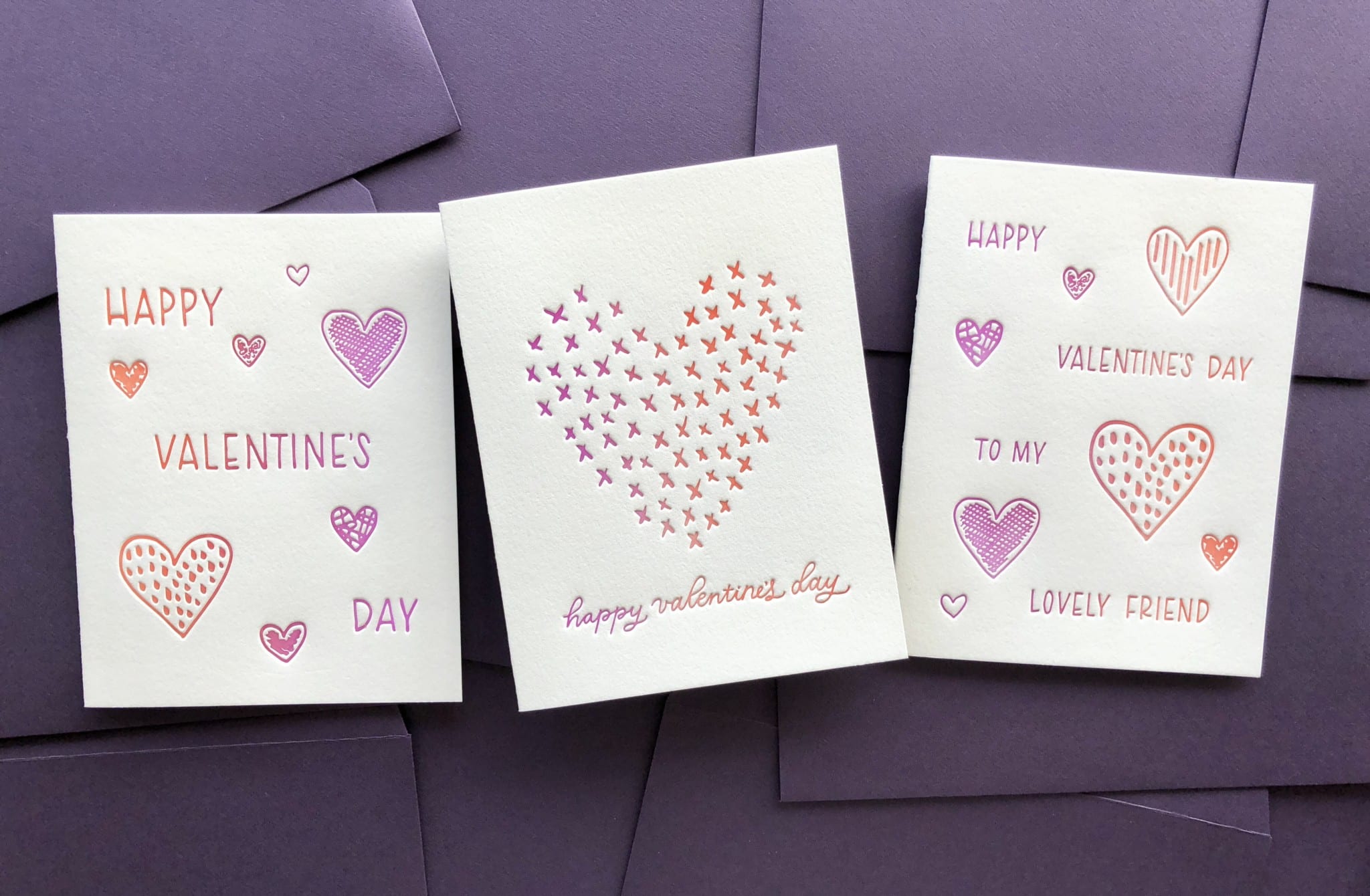 3 greeting cards with a split-color effect on a purple envelope background