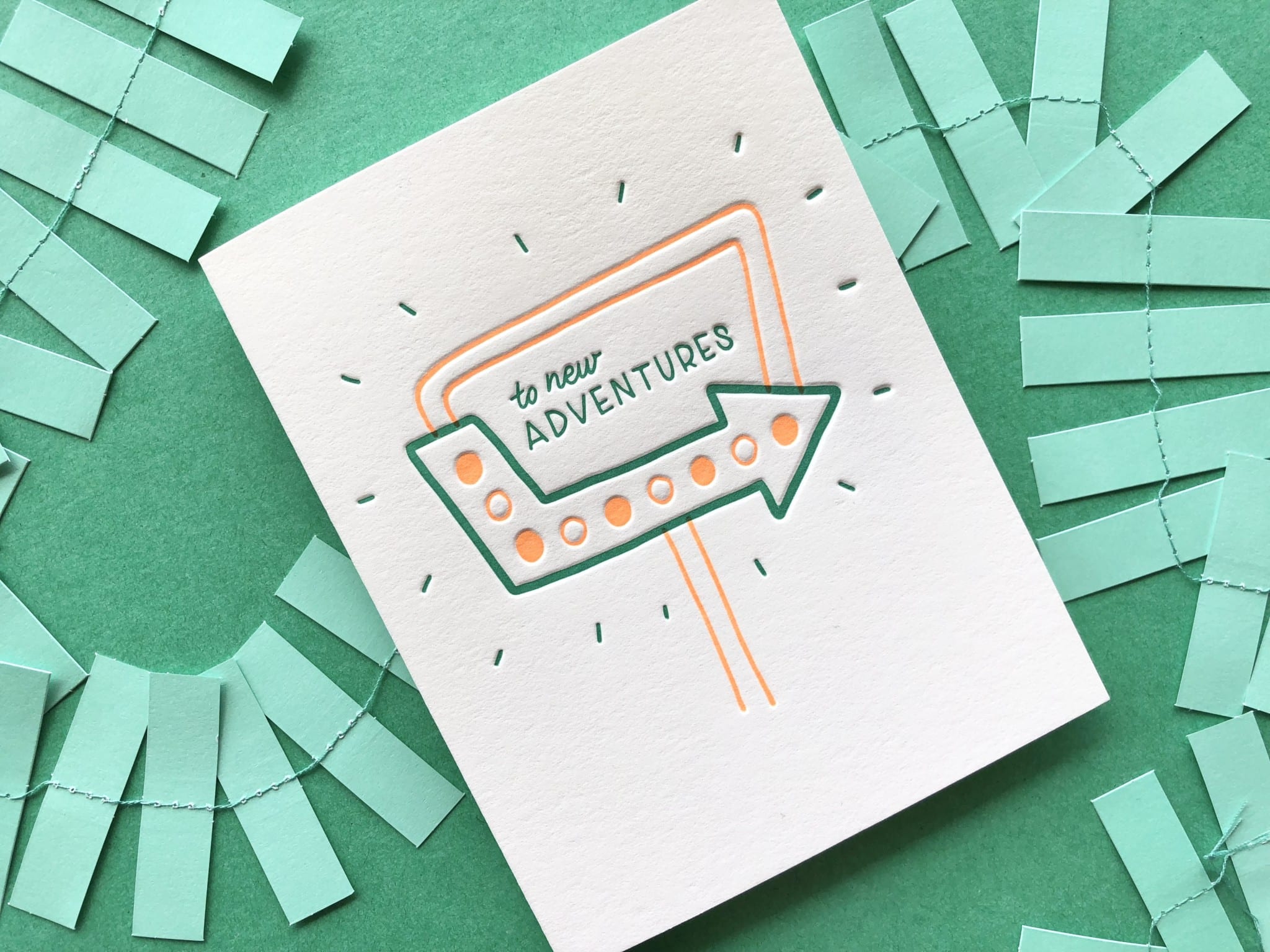 Greeting card on green background with green paper garland.