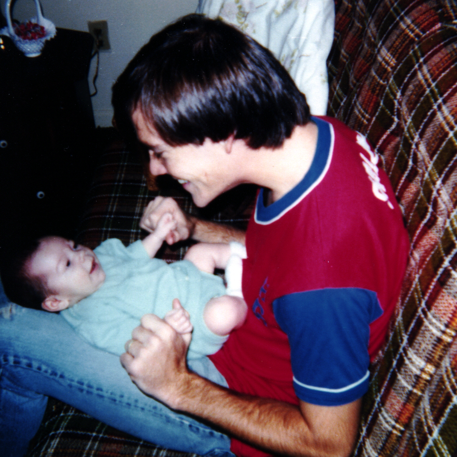 Allison's Dad holding her as a baby