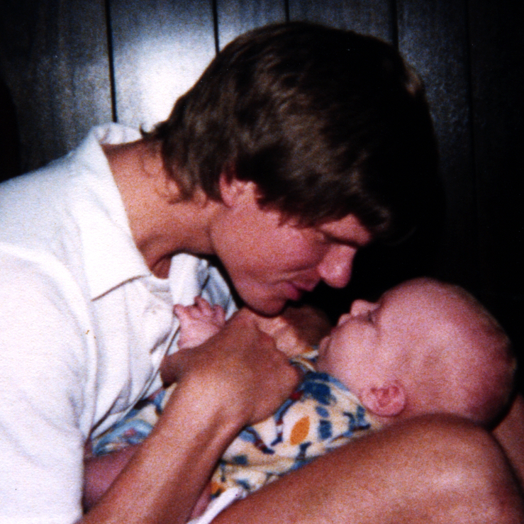Jamie's Dad holding her as a baby.