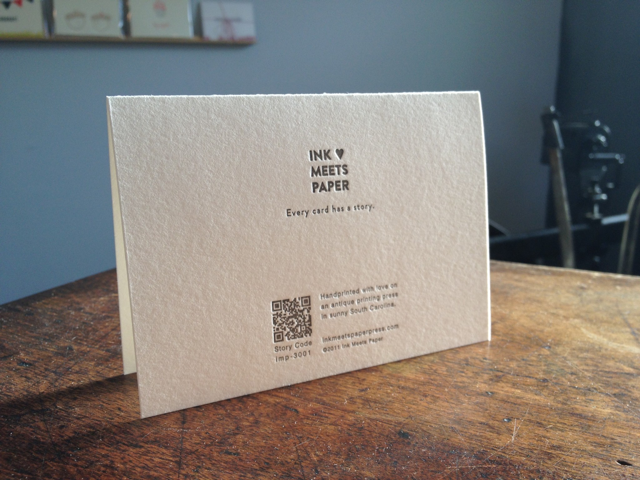 Close-up of card back impression shows the Story Code number and QR code along with INK MEETS PAPER logo