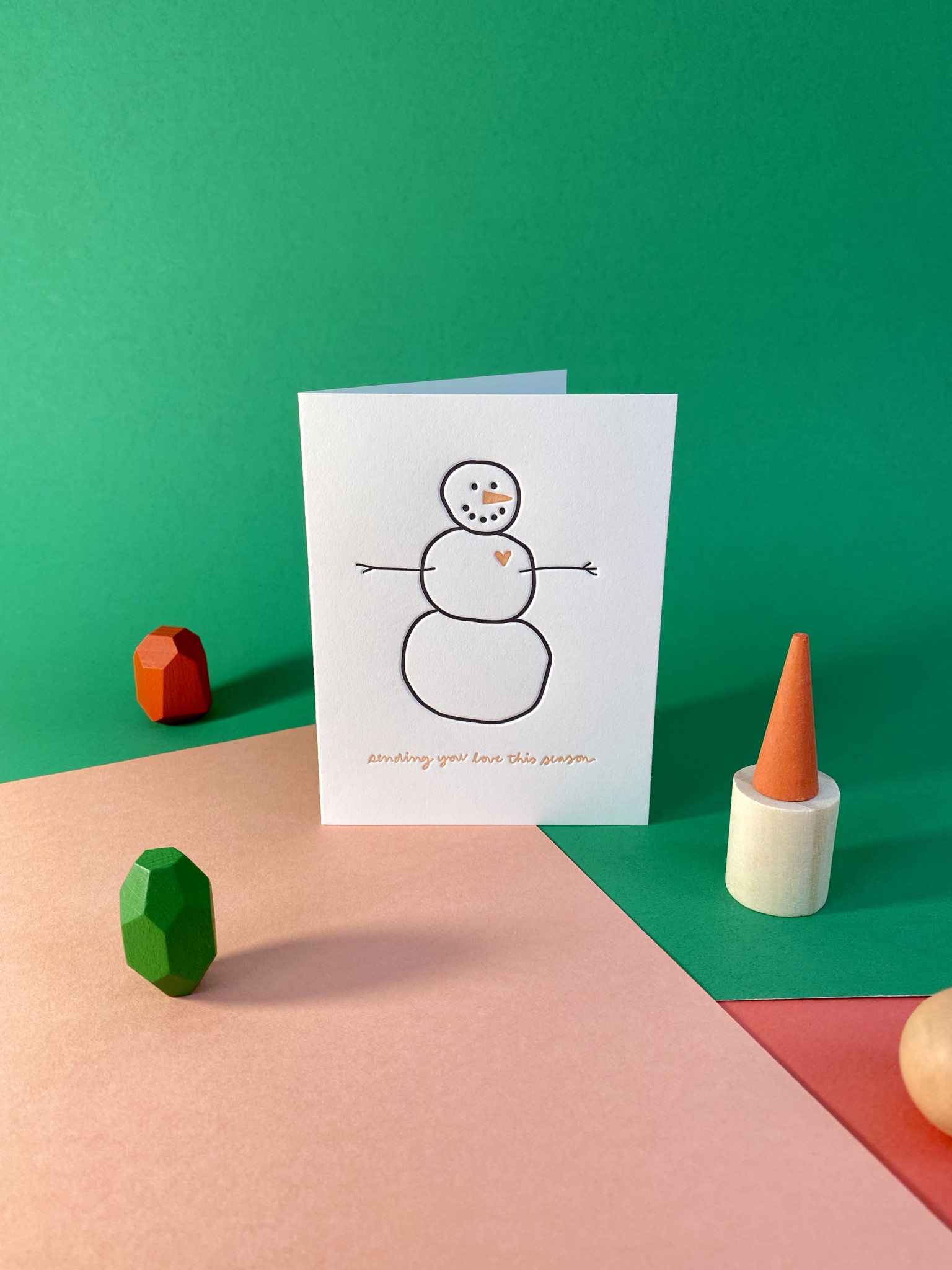 Greeting card with snowman sketch reads, "sending you love this season"
