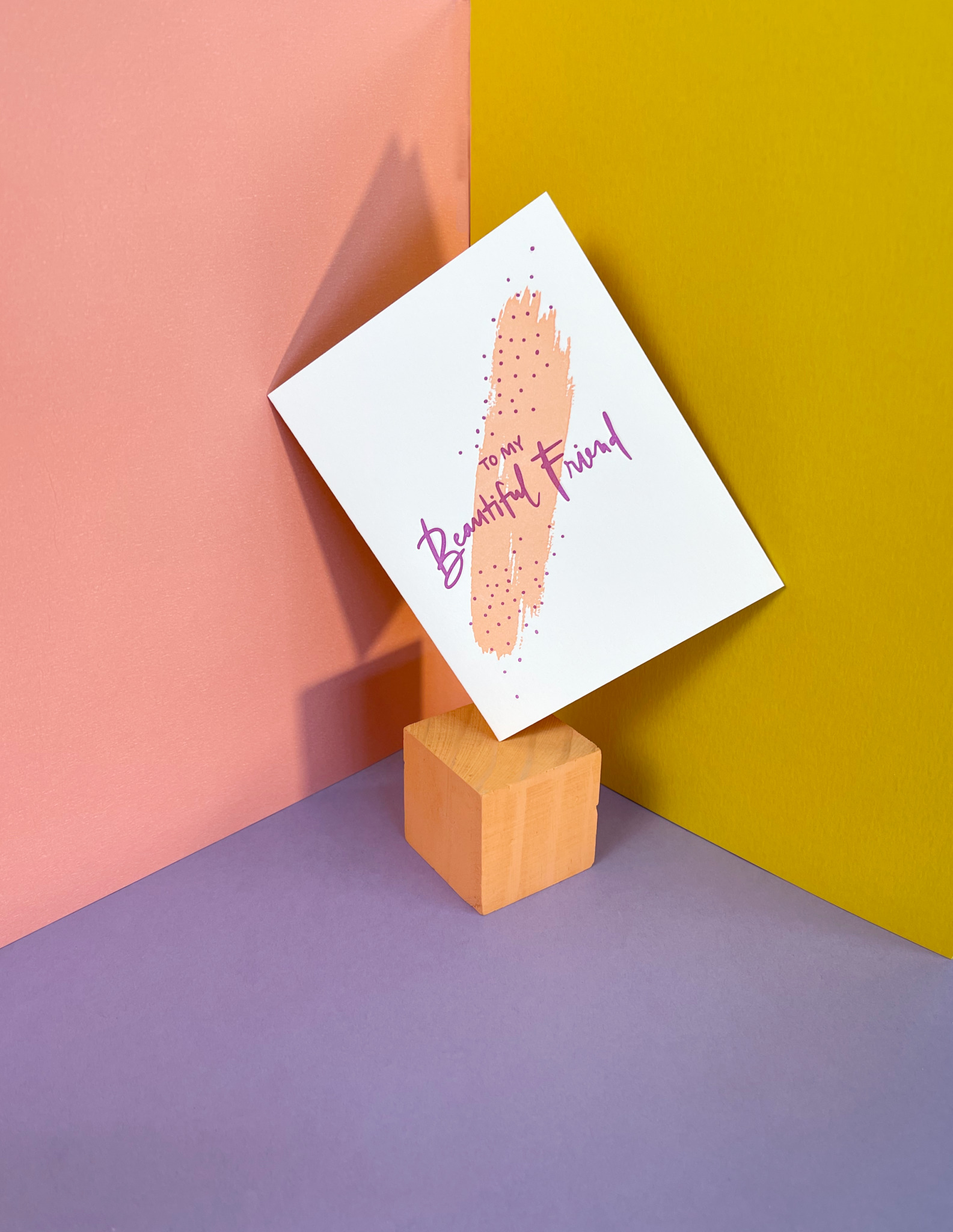 greeting card balanced on a wooden cube